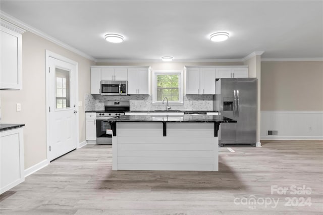 kitchen featuring white cabinets, appliances with stainless steel finishes, sink, and light hardwood / wood-style flooring