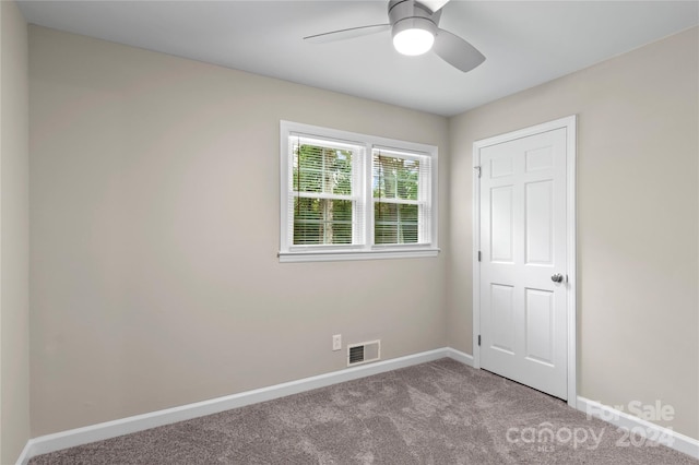 unfurnished bedroom featuring ceiling fan and light colored carpet