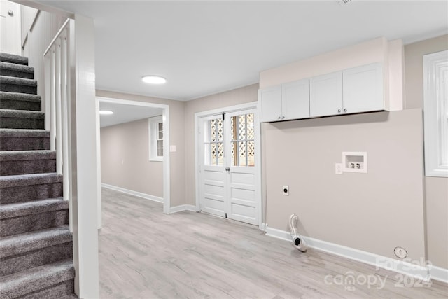 laundry room with washer hookup, hookup for an electric dryer, light wood-type flooring, cabinets, and gas dryer hookup