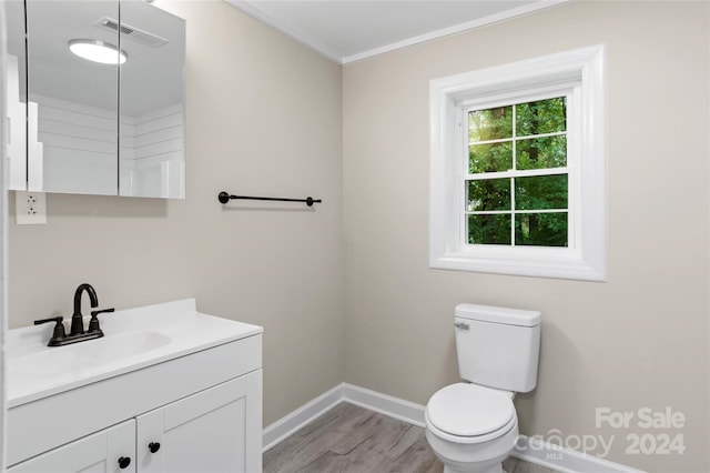 bathroom featuring ornamental molding, vanity, toilet, and hardwood / wood-style flooring