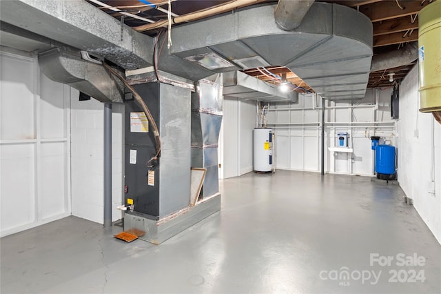 basement featuring water heater and heating unit