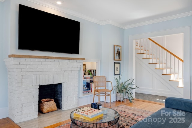 22 Kenilwood Pl, Asheville, NC 28803 - living area with wood finished floors, stairs, ornamental molding, and a brick fireplace