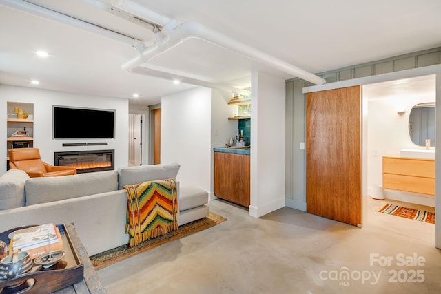 22 Kenilwood Pl, Asheville, NC 28803 - living room with finished concrete floors, a glass covered fireplace, and recessed lighting