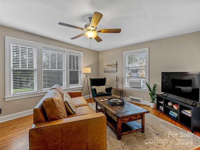 living room featuring cooling unit, hardwood / wood-style flooring, and ceiling fan