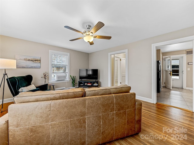 living room with ceiling fan, cooling unit, and hardwood / wood-style floors