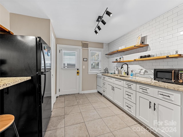 kitchen featuring white cabinetry, black appliances, sink, and backsplash