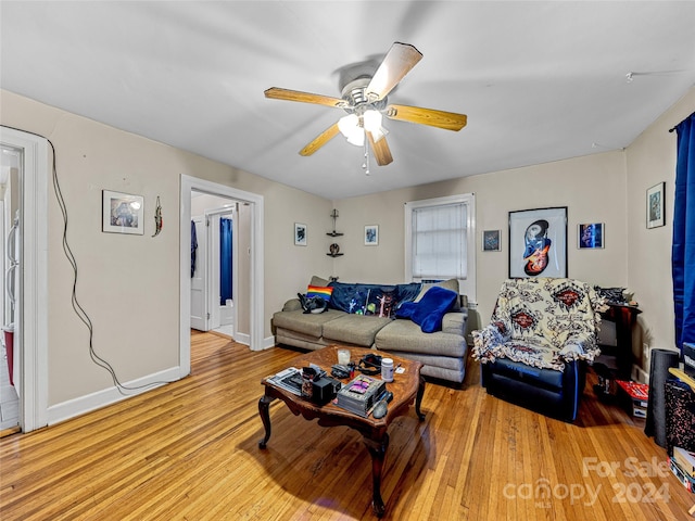 living room with light hardwood / wood-style floors and ceiling fan