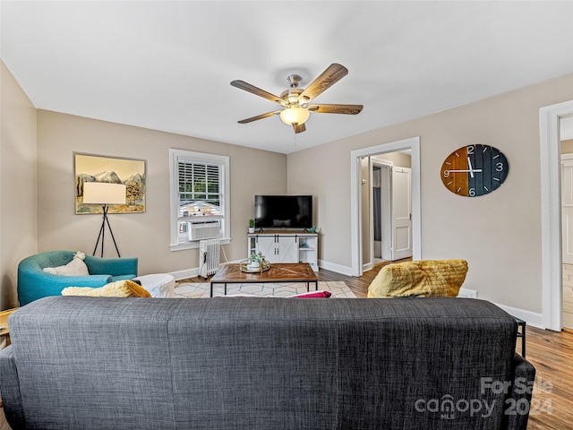 living room featuring cooling unit, light wood-type flooring, and ceiling fan