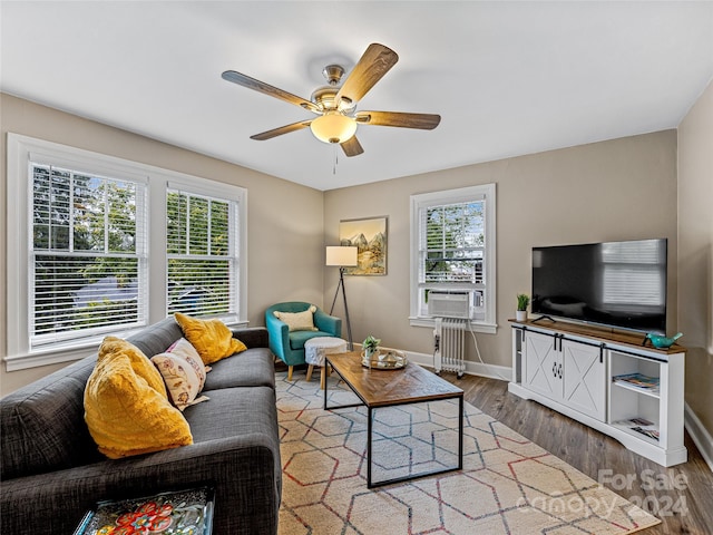 living room with ceiling fan, hardwood / wood-style flooring, and plenty of natural light