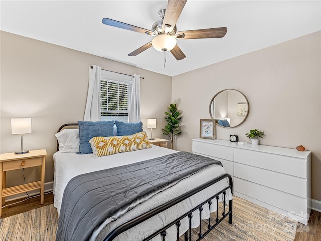 bedroom featuring dark wood-type flooring and ceiling fan