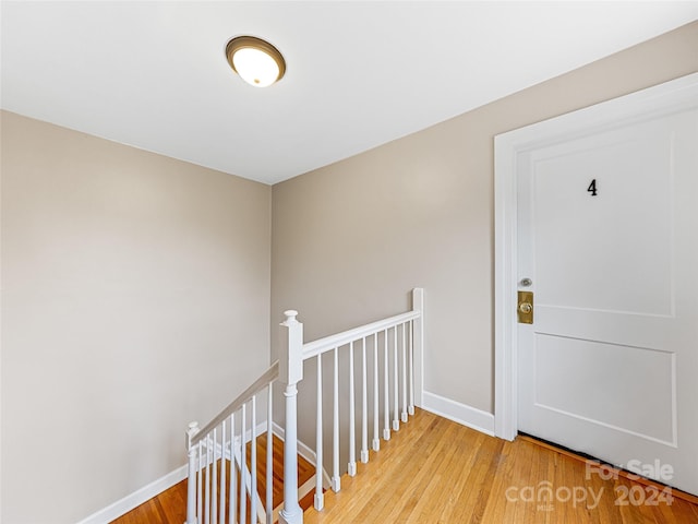 corridor with hardwood / wood-style floors