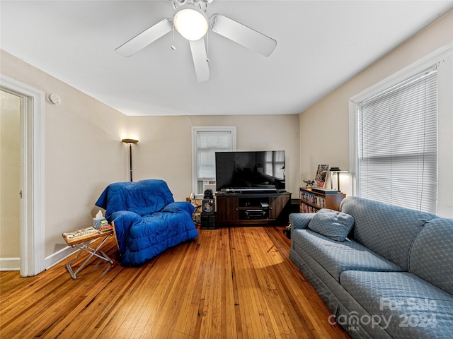 living room with hardwood / wood-style flooring and ceiling fan