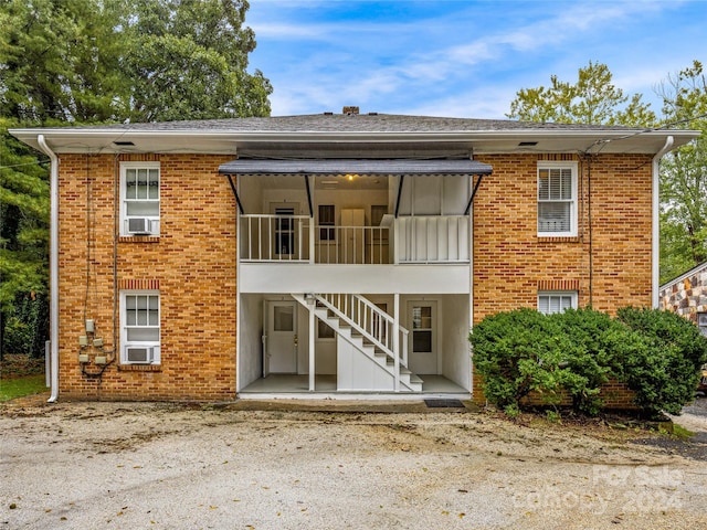 rear view of property featuring cooling unit