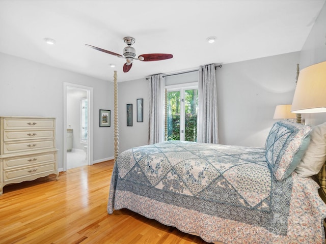 bedroom featuring light hardwood / wood-style floors, ensuite bath, and ceiling fan