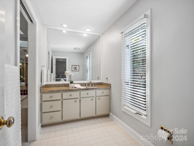 bathroom with tile patterned floors and vanity