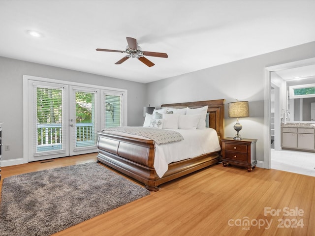 bedroom featuring access to outside, ensuite bath, hardwood / wood-style flooring, and ceiling fan