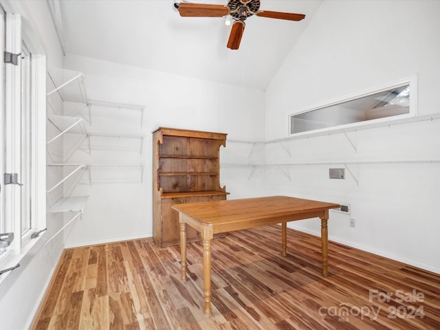 home office featuring ceiling fan, hardwood / wood-style flooring, and high vaulted ceiling