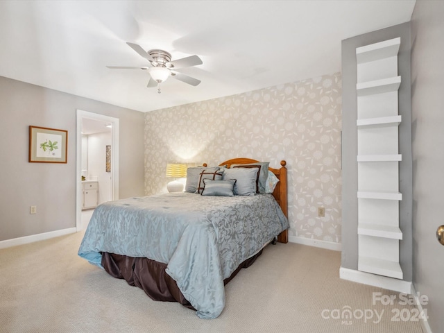 carpeted bedroom featuring ensuite bathroom and ceiling fan