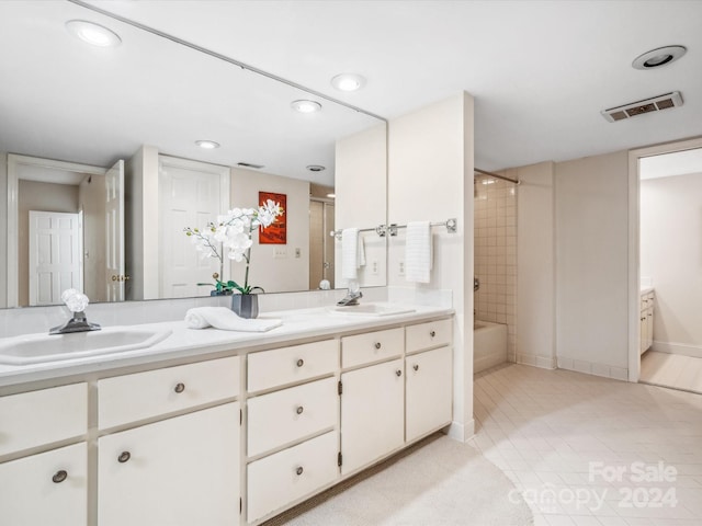 bathroom featuring tile patterned floors, vanity, and tiled shower / bath