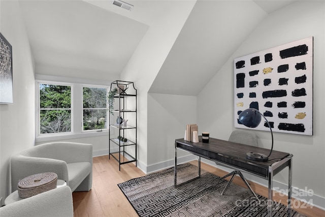 office with hardwood / wood-style flooring and lofted ceiling