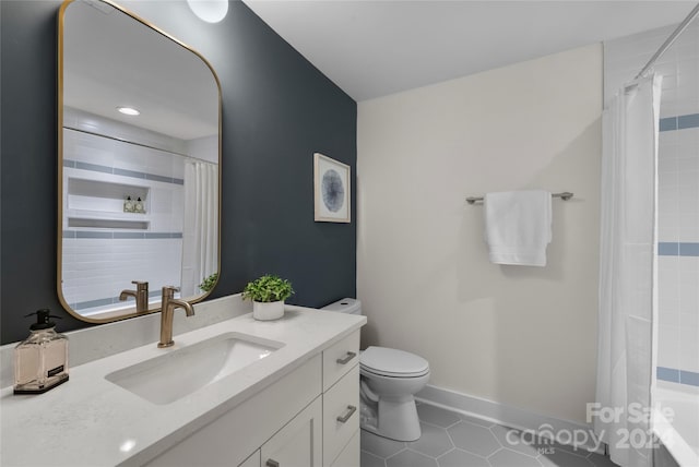 bathroom featuring tile patterned flooring, vanity, and toilet