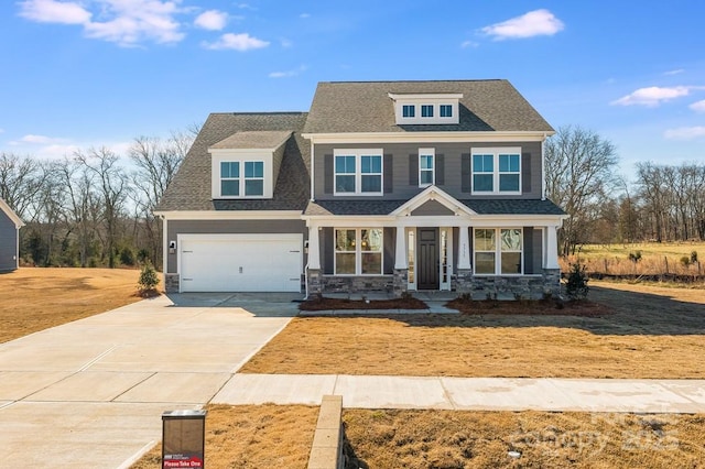 view of front of property featuring a shingled roof and driveway