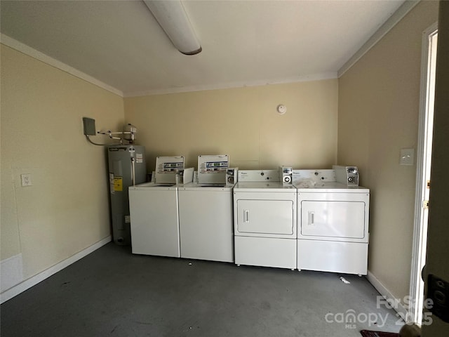 washroom featuring washing machine and dryer, electric water heater, and ornamental molding