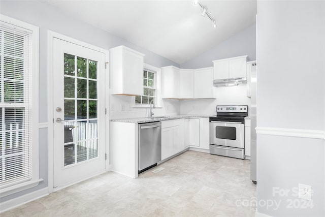 kitchen featuring appliances with stainless steel finishes, lofted ceiling, sink, and white cabinets