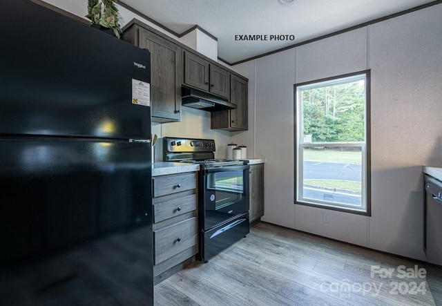 kitchen featuring dark brown cabinets, a textured ceiling, light wood-type flooring, and black appliances