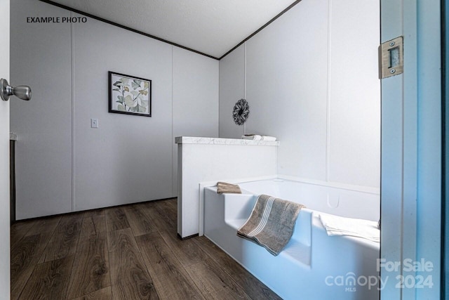 bathroom featuring a textured ceiling and hardwood / wood-style flooring