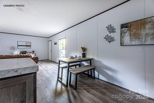 interior space featuring a textured ceiling and dark hardwood / wood-style flooring