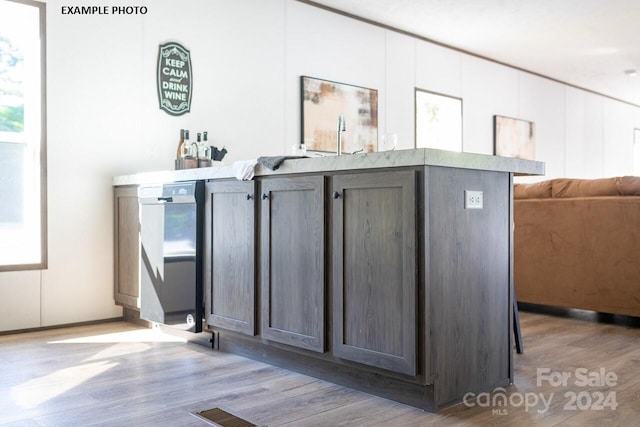 interior space with light wood-type flooring and dark brown cabinets