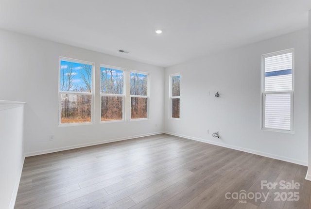 spare room with light hardwood / wood-style floors