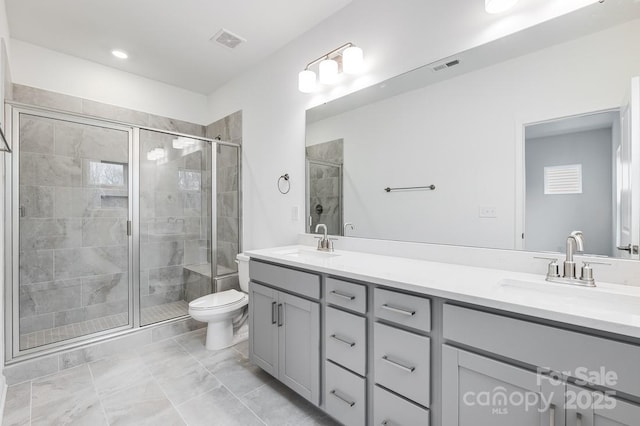 bathroom with vanity, an enclosed shower, and toilet