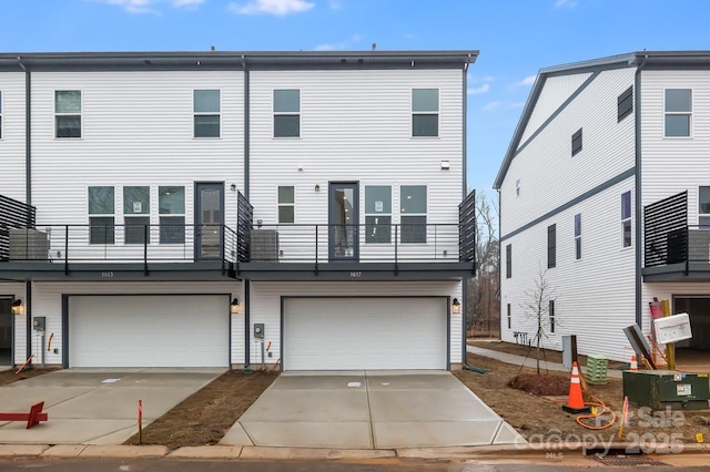 view of front facade with a garage, central AC, and a balcony