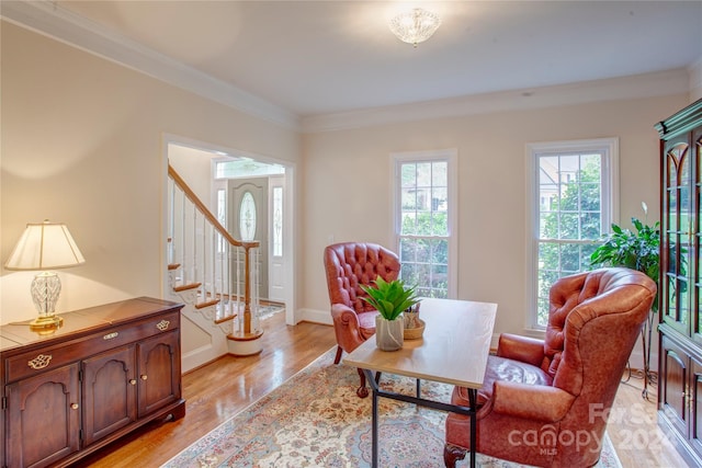 sitting room featuring light hardwood / wood-style floors and crown molding