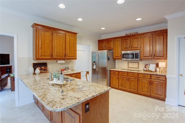 kitchen featuring kitchen peninsula, appliances with stainless steel finishes, light stone counters, and crown molding