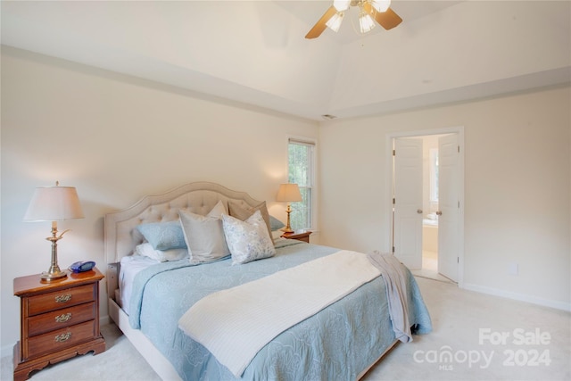 carpeted bedroom with ceiling fan, connected bathroom, and vaulted ceiling