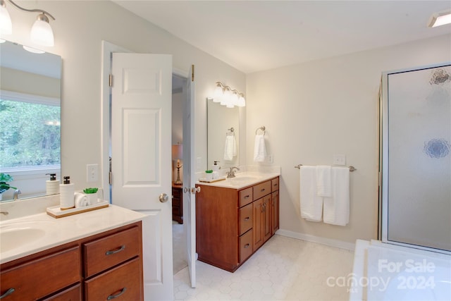 bathroom with vanity and a shower with door