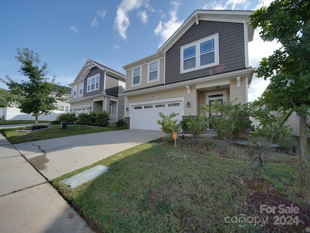 view of front of house featuring a garage and a front yard