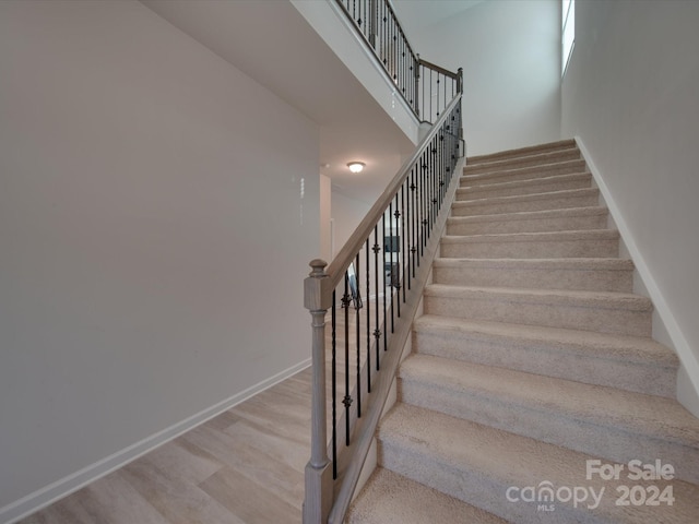 staircase featuring hardwood / wood-style floors