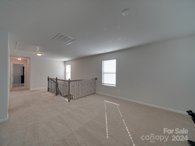 unfurnished room with light colored carpet