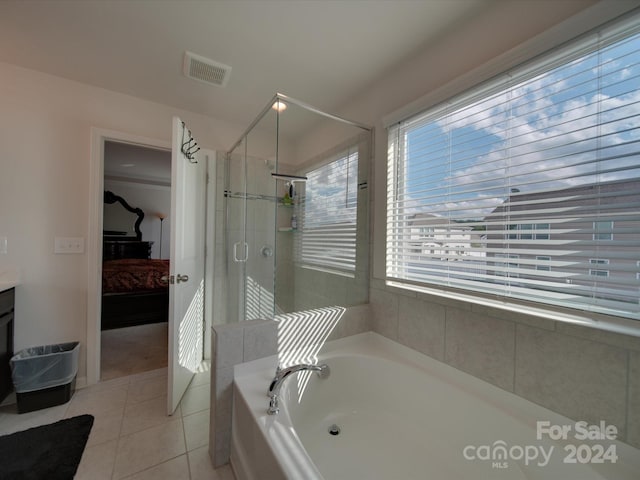 bathroom with shower with separate bathtub, tile patterned flooring, and vanity