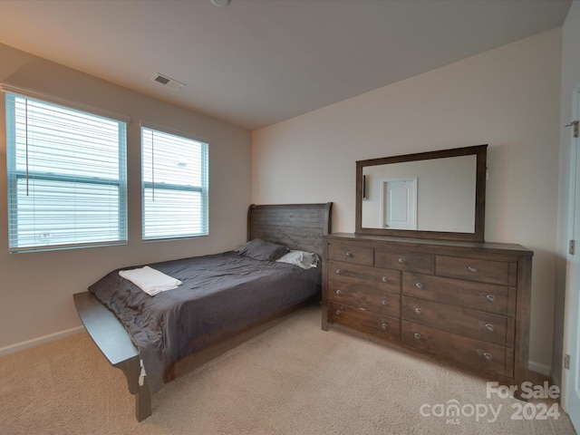 bedroom featuring light carpet