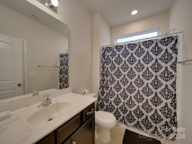 bathroom featuring a shower with curtain, vanity, toilet, and tile patterned floors