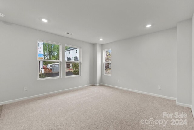 spare room with light colored carpet