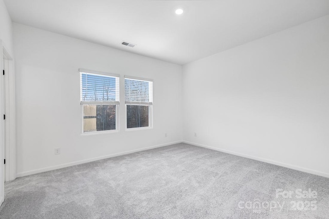 empty room with light colored carpet