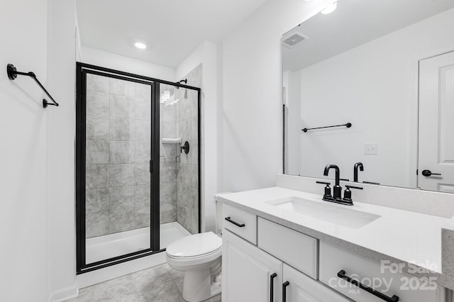 bathroom with toilet, a shower with shower door, and vanity