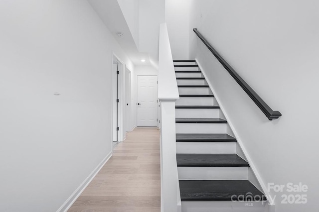 staircase featuring hardwood / wood-style flooring