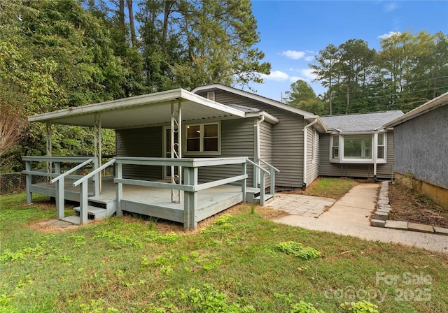 view of side of property featuring a yard and a porch